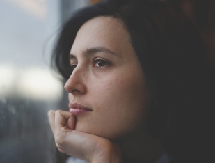 Woman Thinking about Donating Junk Car to Charity or Selling It